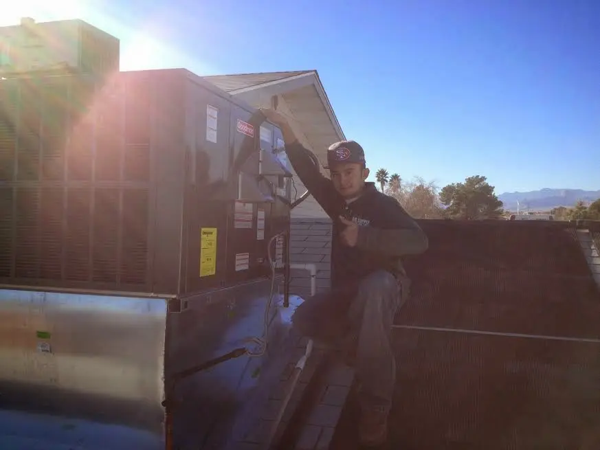 HVAC technician performing HVAC Inspection on a rooftop unit in Valrico